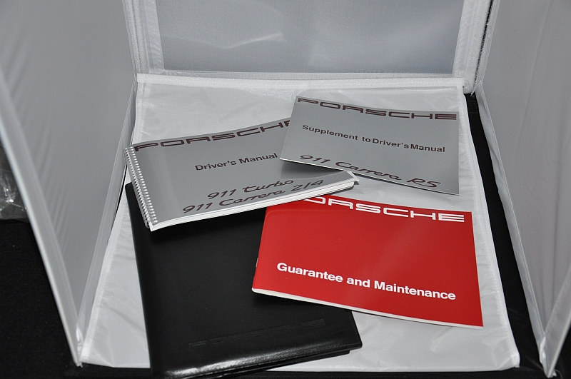 Set of printed Porsche owner's manuals and driver's handbooks